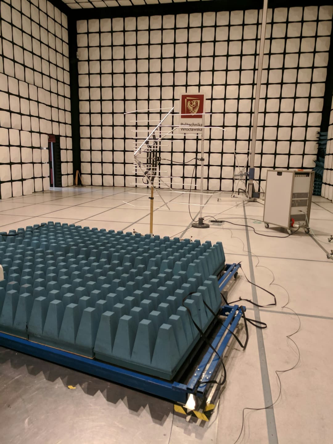 Soundproof acoustic testing chamber with foam-lined walls and precision measurement instruments